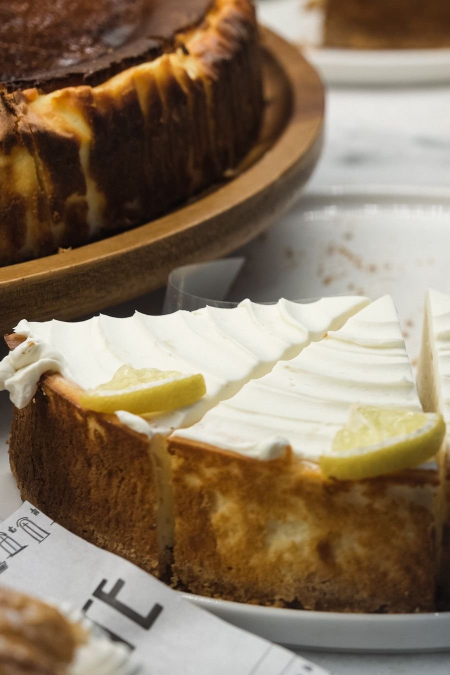 A lemon cheesecake with a thick cream topping